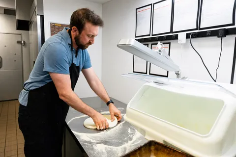 Shaping dough balls at the prep bench