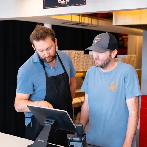 George pointing at a Toast POS screen while walking a teammate through it