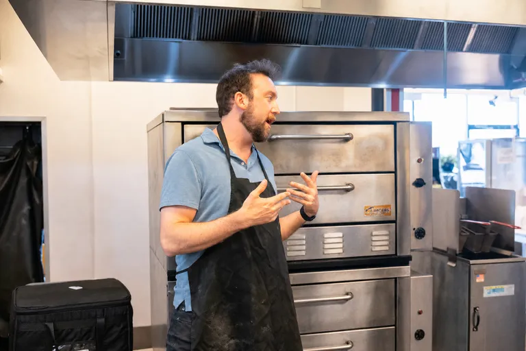 George explaining a process in front of the deck ovens