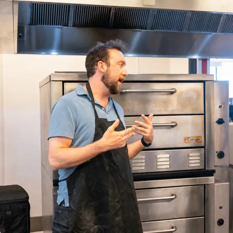 George explaining a process in front of the deck ovens