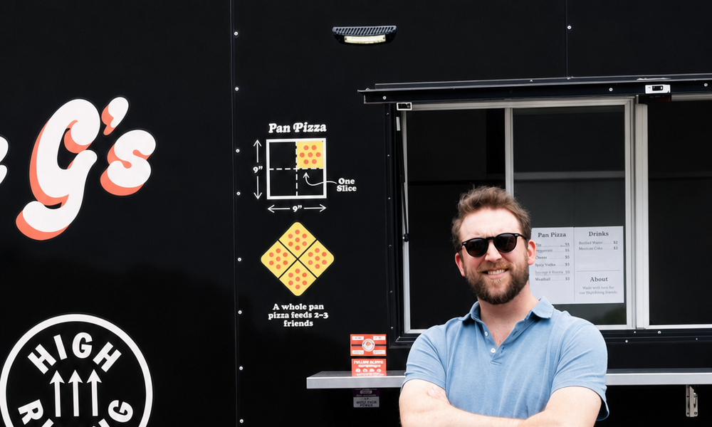 George standing beside the Uncle G’s trailer with a clipboard under his arm