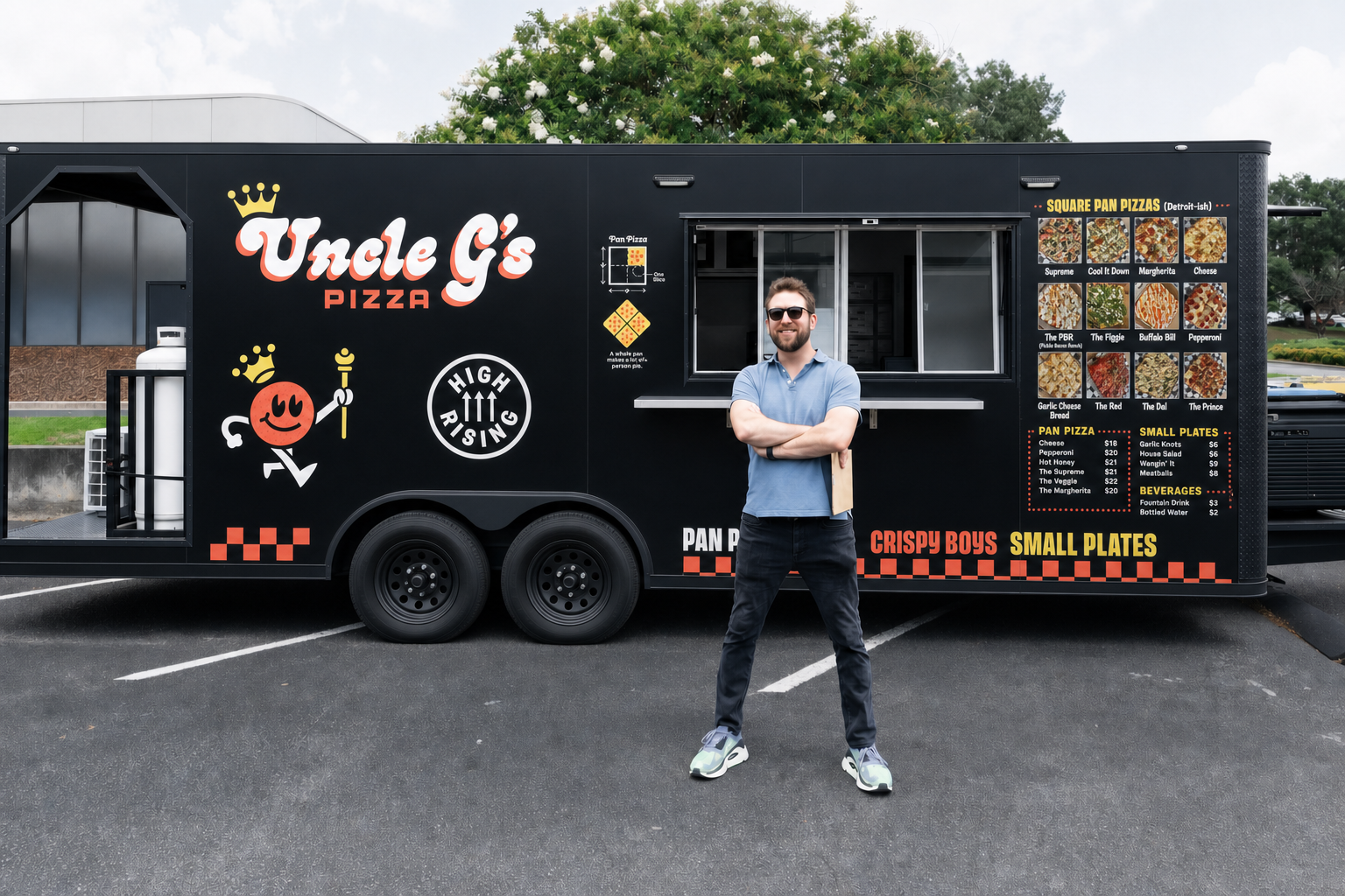 George Gilliam standing with arms crossed in front of the Uncle G's Pizza food trailer